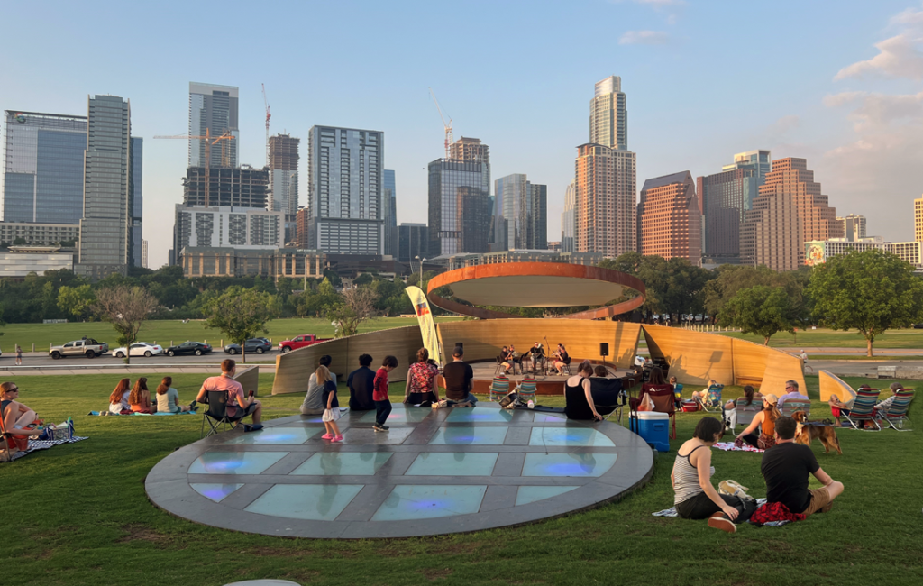 outdoor lawn area with children and stage