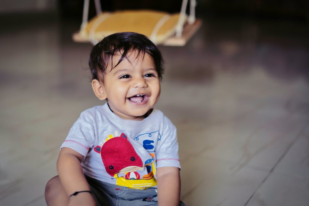 boy in blue and red crew neck t-shirt sitting on yellow and white chair